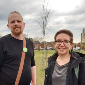 Andy Hunter-Rossall, coordinator of Chorley Green Party, with Carla Denyer, co-leader of the Green Party of England and Wales standing near newly planted trees at Buttermere playing fields